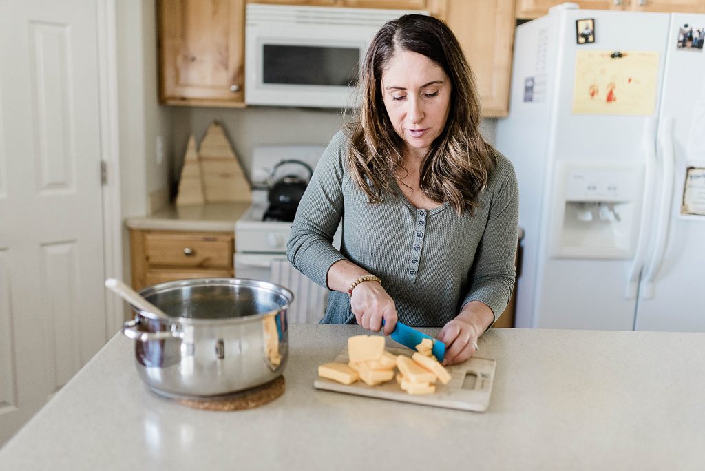 Image of Andie cubing the Velveeta cheese for the broccoli soup. 