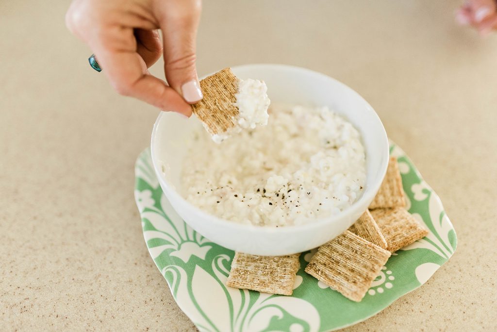 Creamy cottage cheese and tuna dip with no mayonnaise and fresh cracker pepper on top  served with wheat crackers 