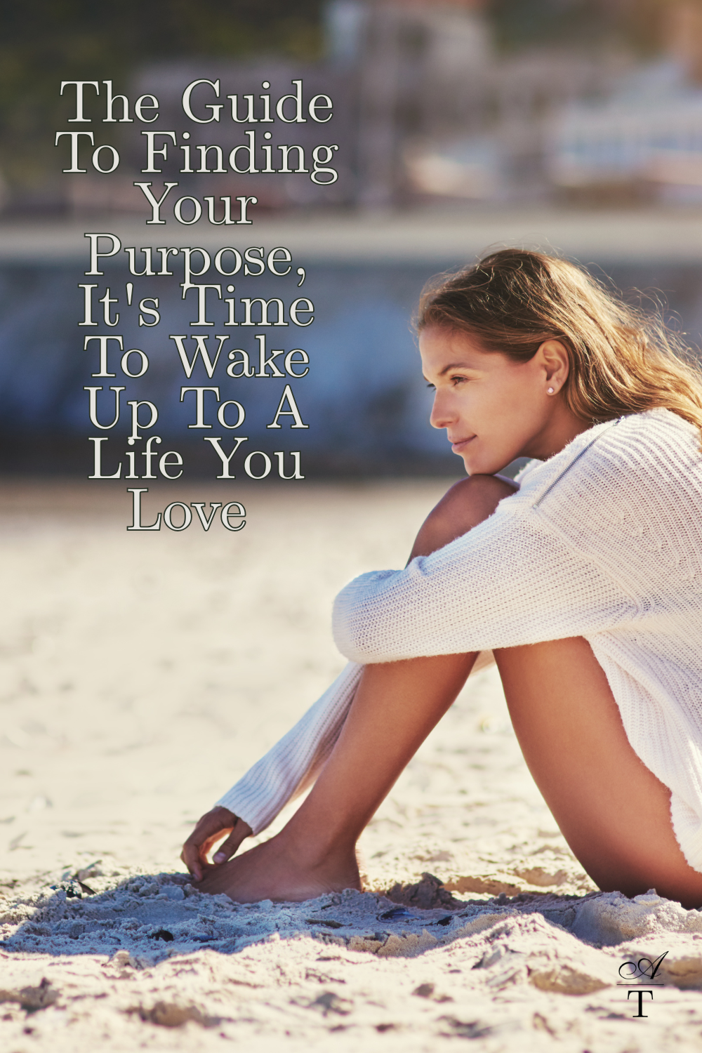 Image of woman sitting on the beach in a cream sweater, she looks deep in contemplation. The Words "The Guide To Finding Your Purpose, It's Time To Wake Up To a Life You Love" written on the image. 