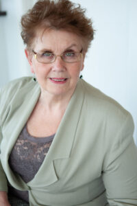 Photo of Carol Metz Murray recent guest on the Own Your Piece Podcast. In the photo Carol is wearing a sage green blazer and a lace top she is the embodiment of self-leadership for women. 